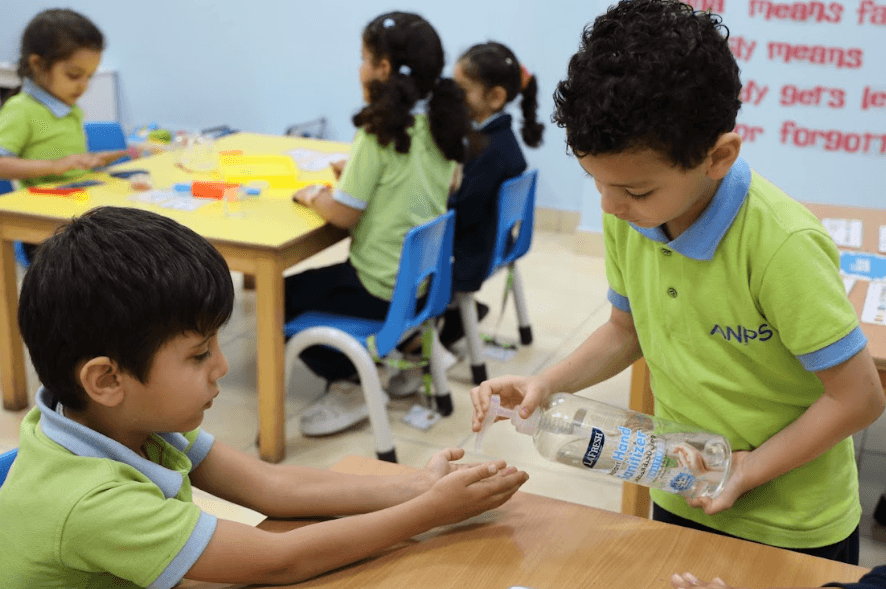 A young child taking part in a daily classroom job