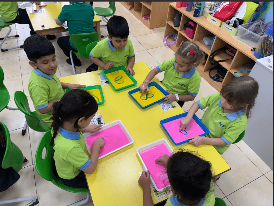 Young children working together at small-group learning stations