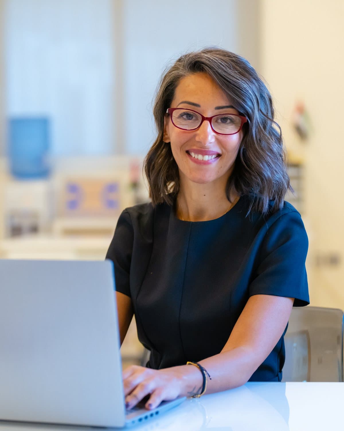 Portrait of the Al Najah Private School principal at her desk